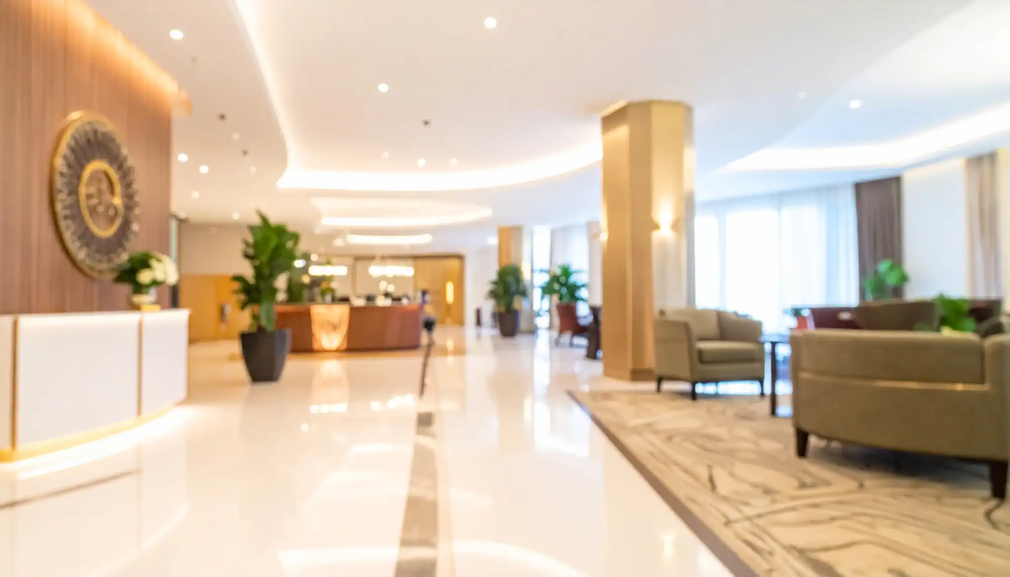 Hotel lobby with reception desk and guest seating areas